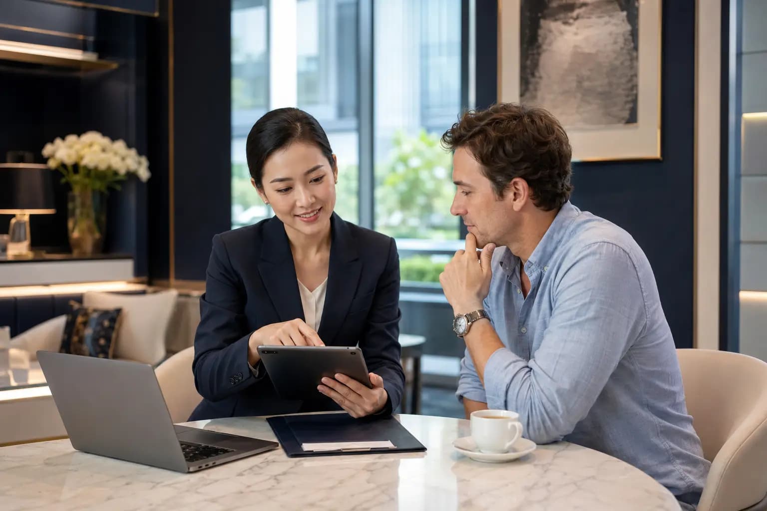 A consultant and visitor reviewing verification details on a tablet before a healthcare decision