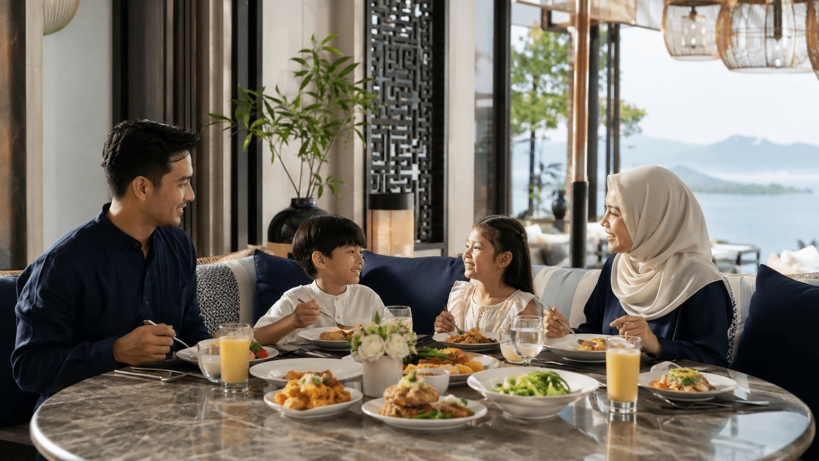 A family sharing a Thai meal together at a warm, welcoming restaurant table by the coast.